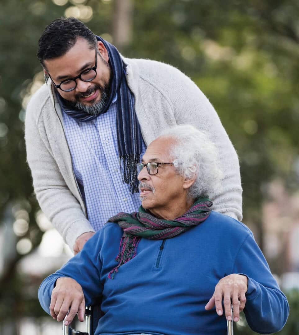 man-helping-senior-in-wheelchair