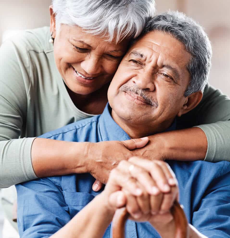 man-with-cane-embracing-wife