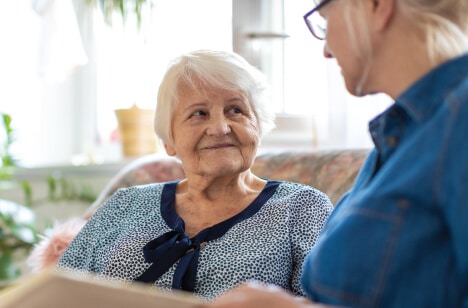 senior-woman-and-daughter-reading