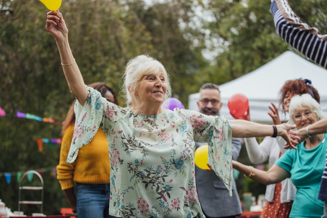 senior female dancing in the garden at a celebration