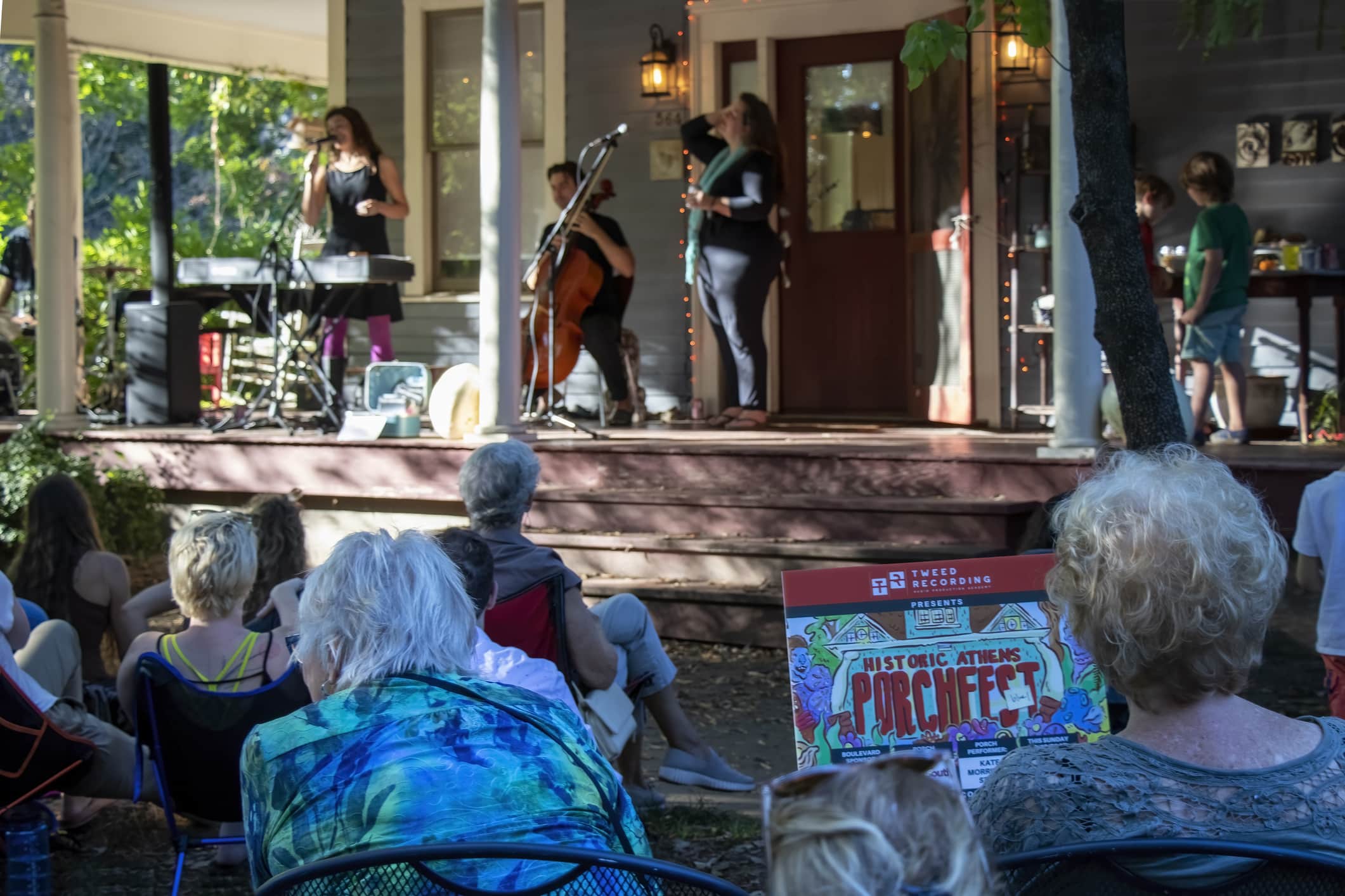 An audience sits in the shade around a porch concert by the Kate Morrisey group during Porchfest 2021 in Athens, Georgia, USA